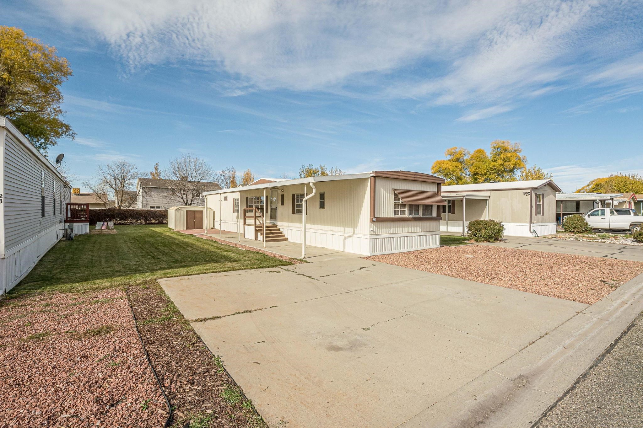 3251 E Road, Unit 22 Clifton, CO 81520 - Photo 29 of 29 a view of a white house with a yard
