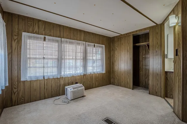 a view of a hallway with wooden shelves