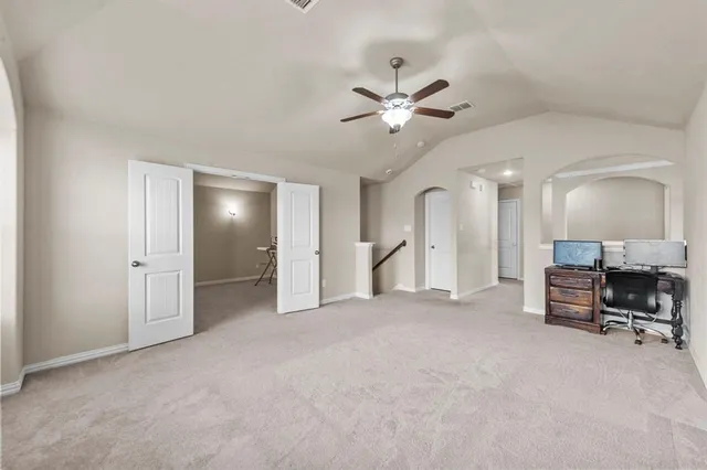 a view of a livingroom with a furniture and a ceiling fan