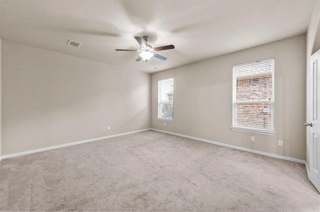 11620 Beach Street Frisco, TX 75036 - Photo 17 of 28 an empty room with a window and a ceiling fan