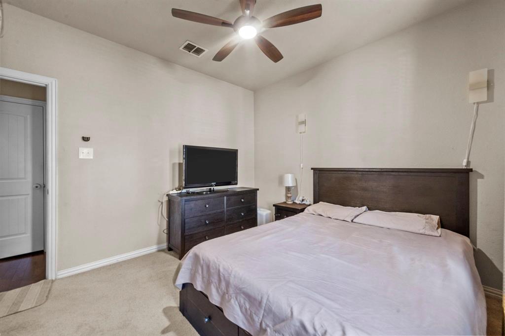 11620 Beach Street Frisco, TX 75036 - Photo 18 of 28 a bedroom with a bed and a flat screen tv