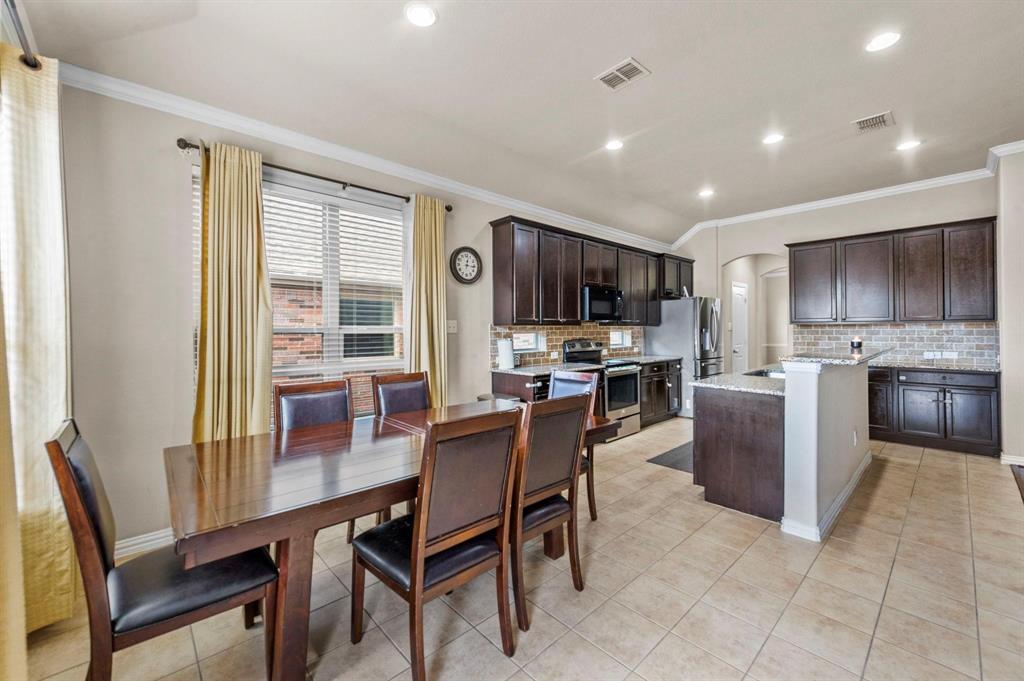 11620 Beach Street Frisco, TX 75036 - Photo 19 of 28 a view of a dining room with furniture a kitchen and chandelier