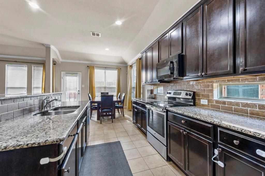 11620 Beach Street Frisco, TX 75036 - Photo 20 of 28 a large kitchen with granite countertop lots of counter space a sink and appliances