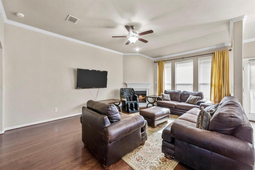 11620 Beach Street Frisco, TX 75036 - Photo 22 of 28 a living room with furniture a ceiling fan and a large window