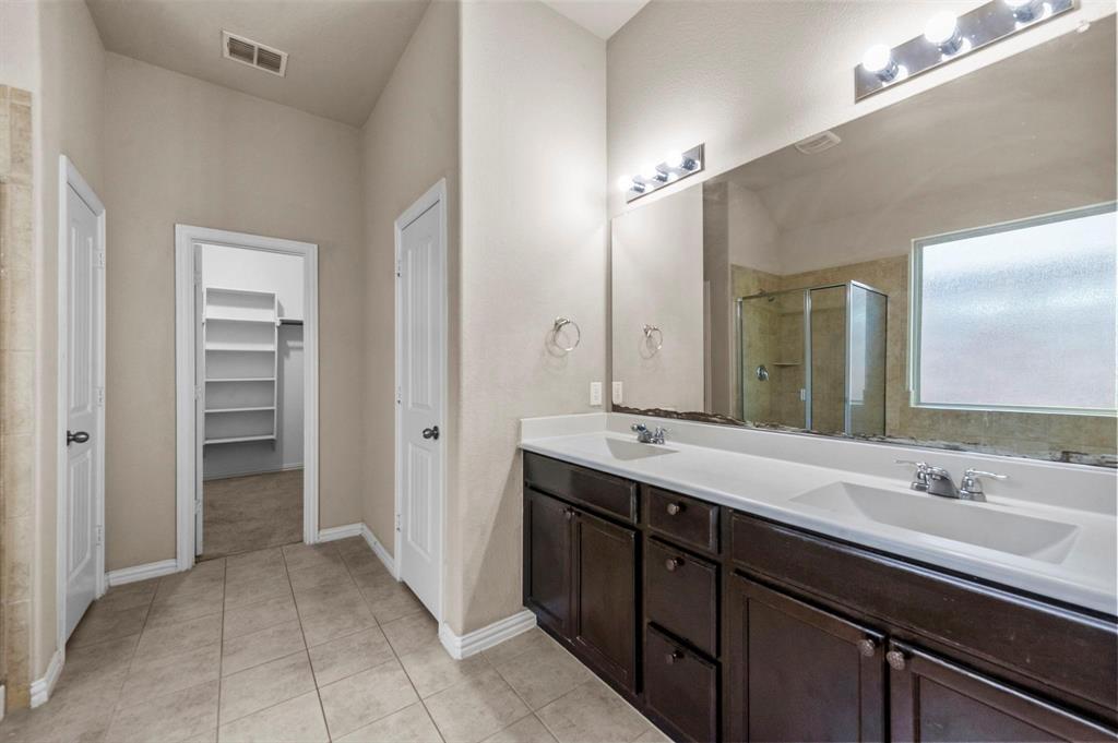 11620 Beach Street Frisco, TX 75036 - Photo 24 of 28 a spacious bathroom with a double vanity sink a and a mirror