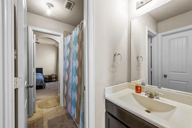 a en suite bathroom with a sink a mirror and a shower