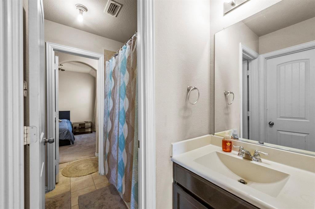 11620 Beach Street Frisco, TX 75036 - Photo 26 of 28 a en suite bathroom with a sink a mirror and a shower