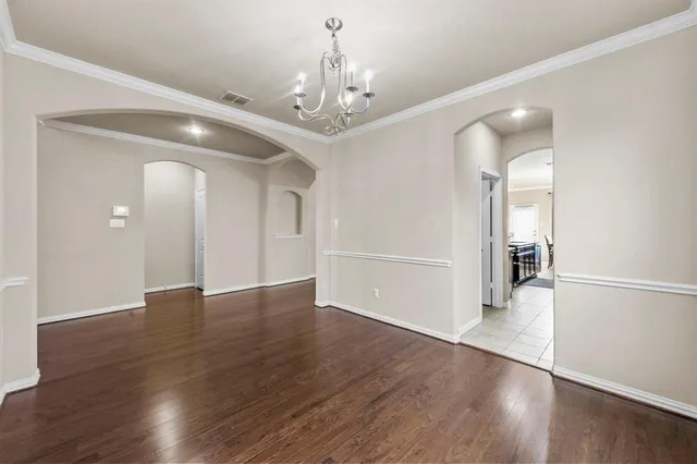 a view of a room with wooden floor