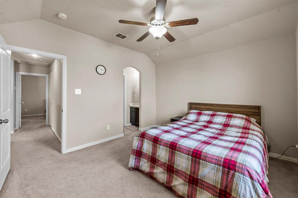 11620 Beach Street Frisco, TX 75036 - Photo 5 of 28 a bedroom with a bed and a chandelier
