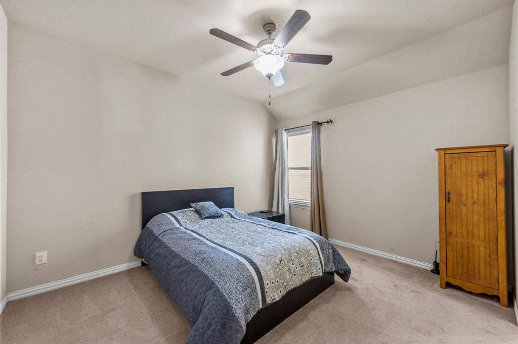 11620 Beach Street Frisco, TX 75036 - Photo 7 of 28 a bedroom with a bed and a ceiling fan