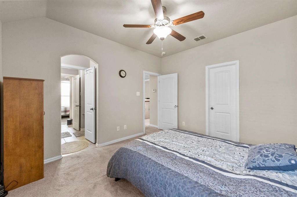 11620 Beach Street Frisco, TX 75036 - Photo 8 of 28 a bedroom with a large bed and a chandelier