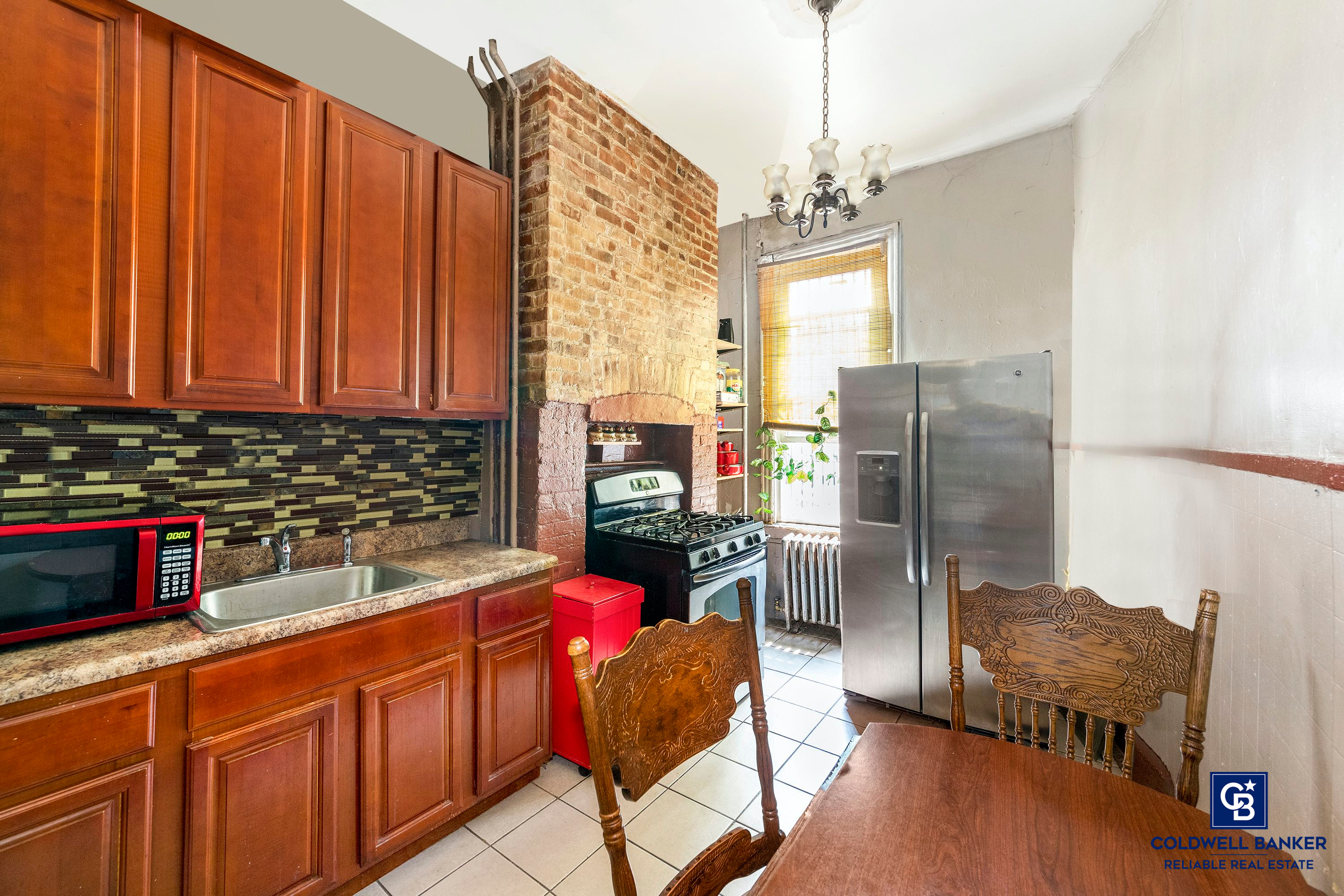 20 Weirfield Street Brooklyn, NY 11221 - Photo 2 of 12 a kitchen with refrigerator cabinets and wooden floor