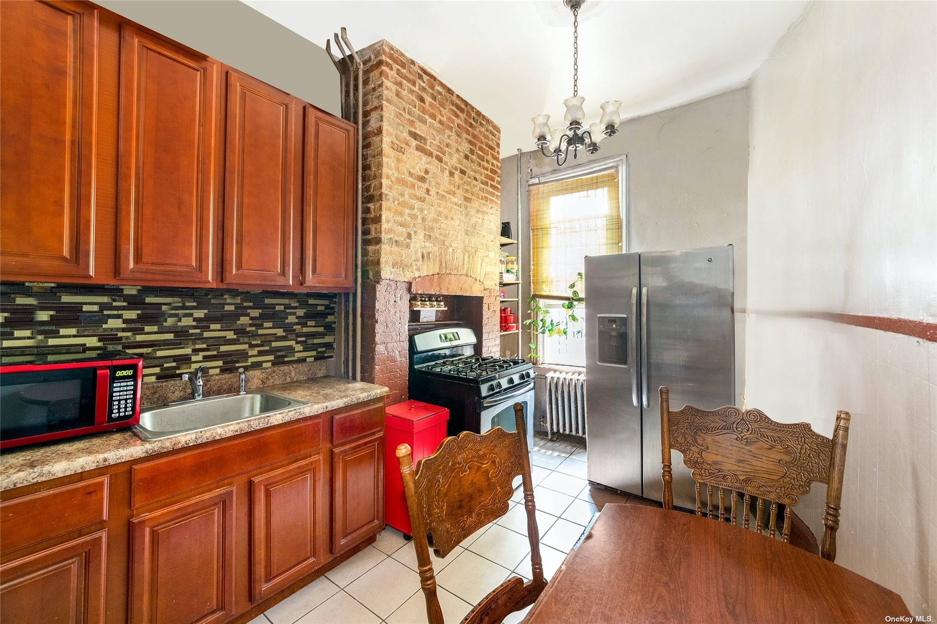 20 Weirfield Street Brooklyn, NY 11221 - Photo 3 of 12 a kitchen with stainless steel appliances granite countertop a refrigerator and a sink