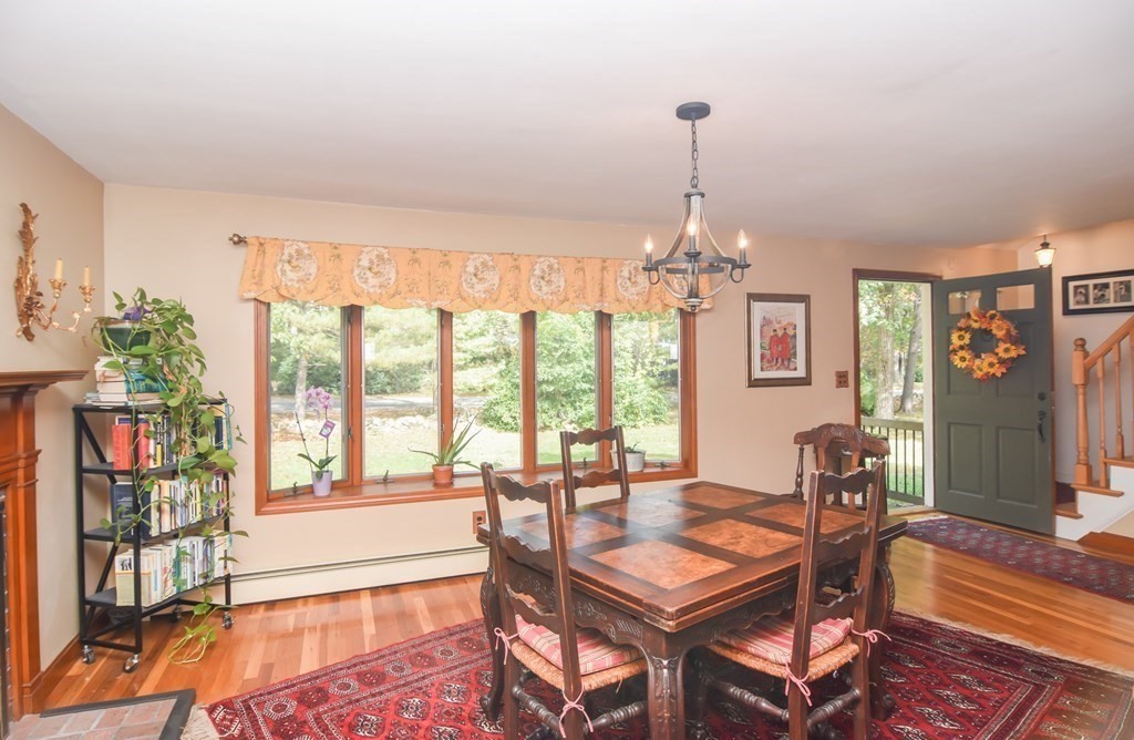 310 Ipswich Road Boxford, MA 01921 - Photo 3 of 32 a dining room with furniture large windows and wooden floor