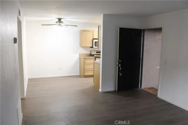 a view of a kitchen with a sink and refrigerator