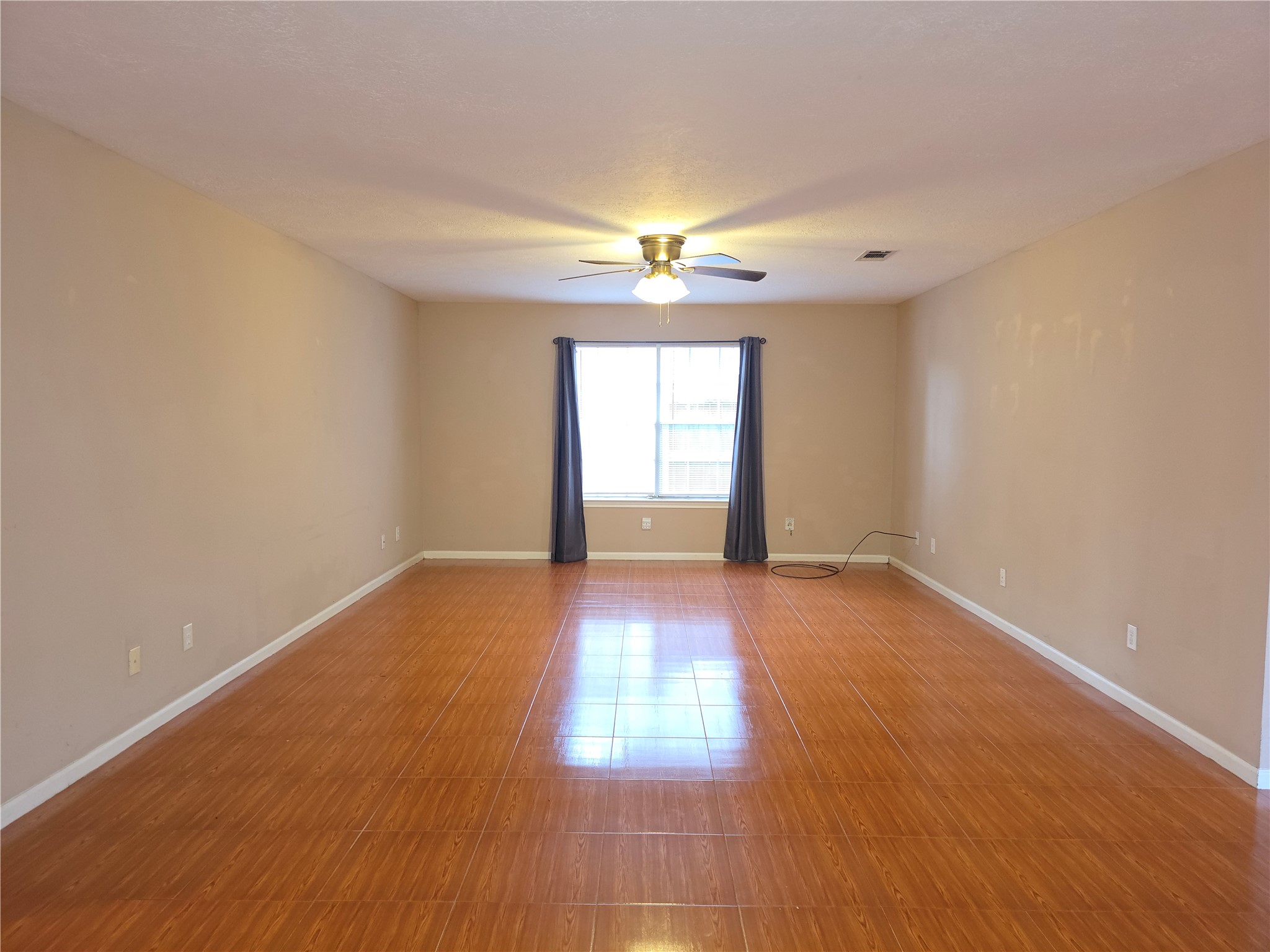 414 Texas Street Tomball, TX 77375 - Photo 3 of 8 wooden floor in an empty room with a window