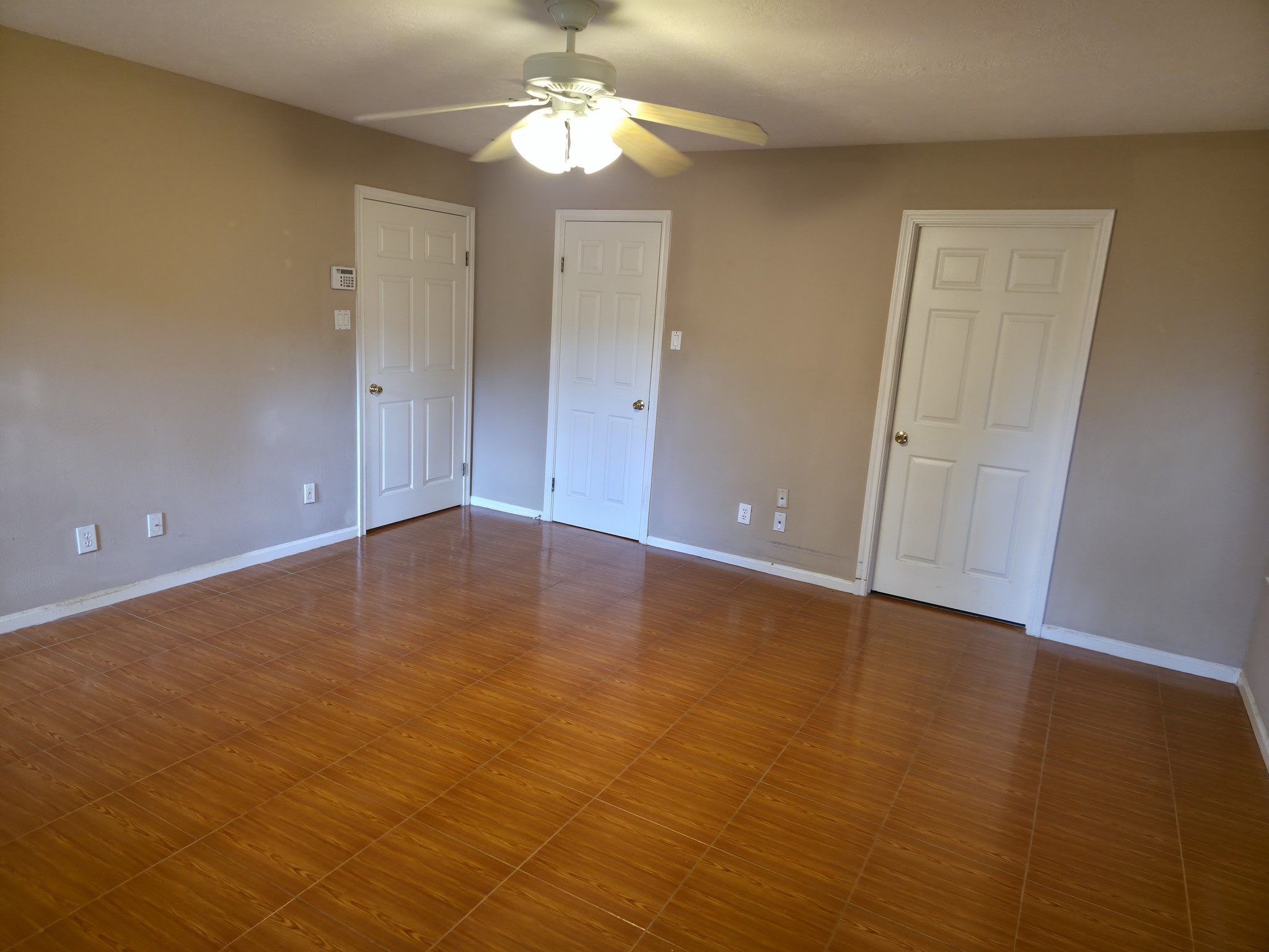 414 Texas Street Tomball, TX 77375 - Photo 4 of 8 an empty room with closet and wooden floor