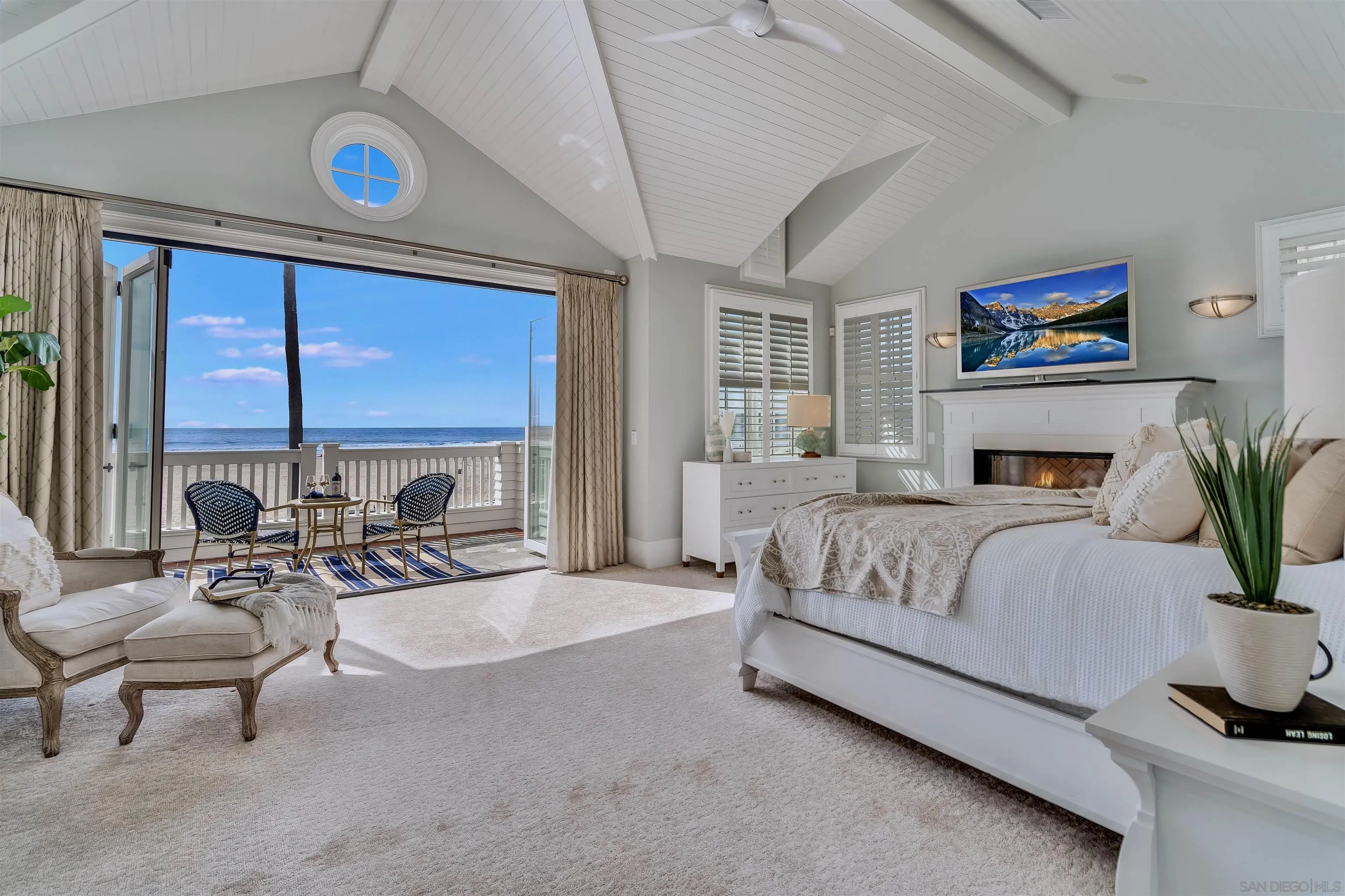 919 Ocean Boulevard Coronado, CA 92118 - Photo 26 of 63 a spacious bedroom with a balcony a large bed and a couch
