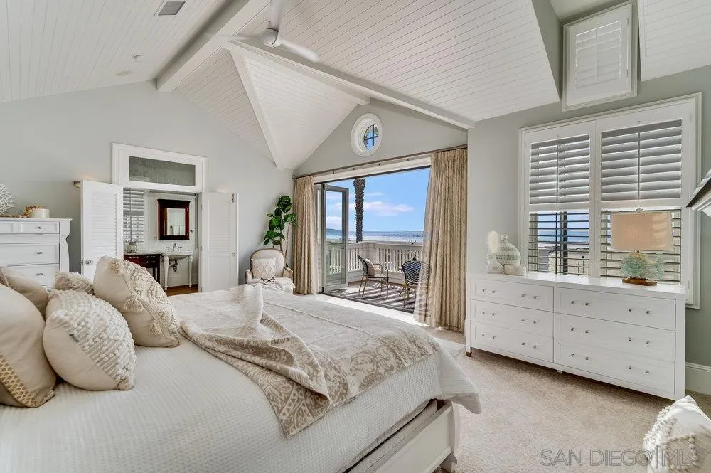 919 Ocean Boulevard Coronado, CA 92118 - Photo 28 of 63 a bedroom with a large bed and a large window