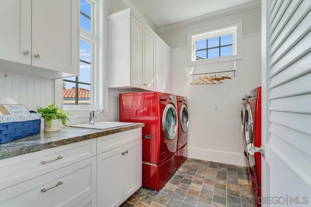 919 Ocean Boulevard Coronado, CA 92118 - Photo 55 of 63 a utility room with granite countertop a sink a washer and dryer