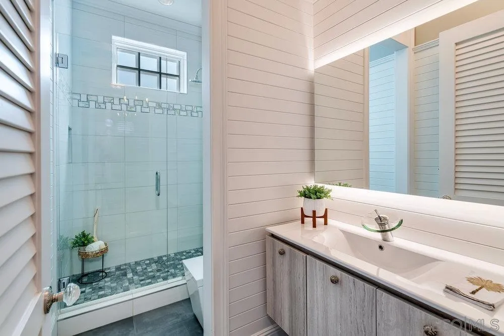 919 Ocean Boulevard Coronado, CA 92118 - Photo 56 of 63 a bathroom with a sink and a mirror