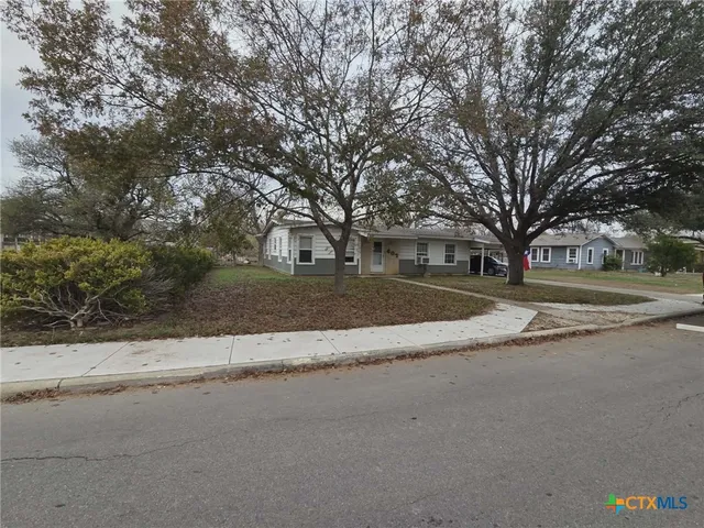 a view of street with with large trees