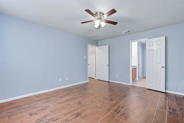 a view of an empty room with wooden floor