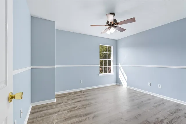 wooden floor in an empty room with a window