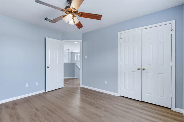 a view of an empty room with wooden floor