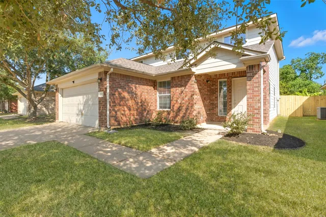 a view of a house with a yard and garage