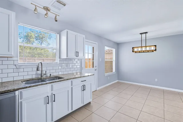 a kitchen with a sink cabinets and window