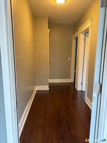 a view of a hallway with wooden floor