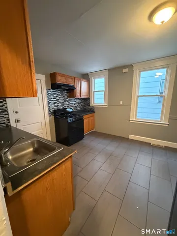 a kitchen with a stove a sink and a refrigerator