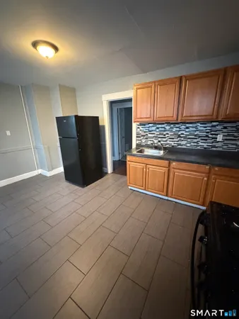 a view of kitchen with stainless steel appliances granite countertop cabinets and outdoor space