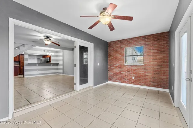 a view of an entryway with a chandelier fan