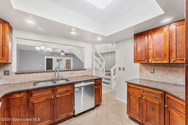 a kitchen with stainless steel appliances granite countertop a sink stove and cabinets