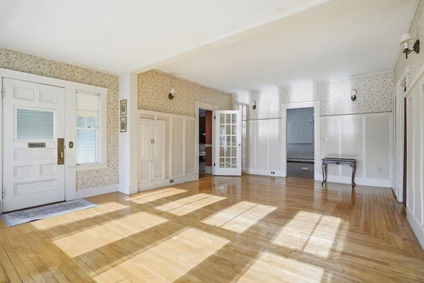 a spacious bedroom with a bed and cabinets