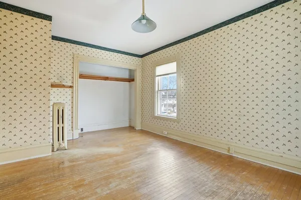 an empty room with a empty space and a window