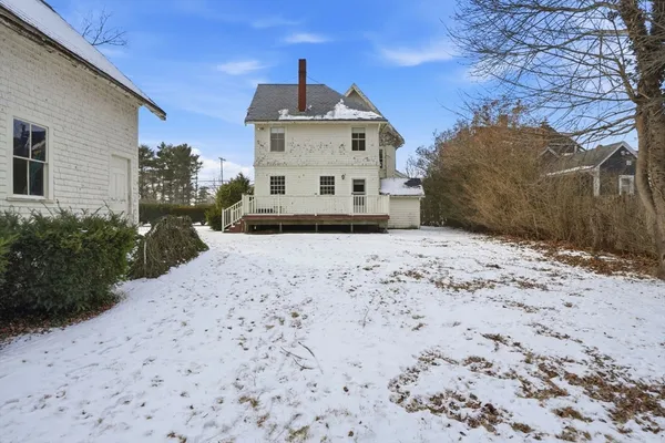 a view of a white house with a yard
