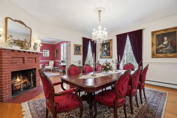 a view of a dining room with furniture a chandelier and wooden floor