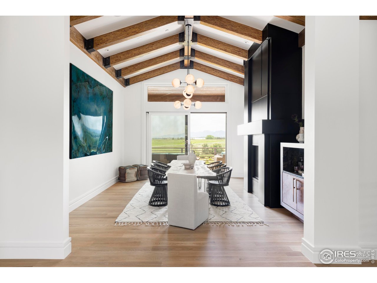 6880 St Vrain Road Longmont, CO 80503 - Photo 13 of 37 a view of a dining room with furniture window and wooden floor