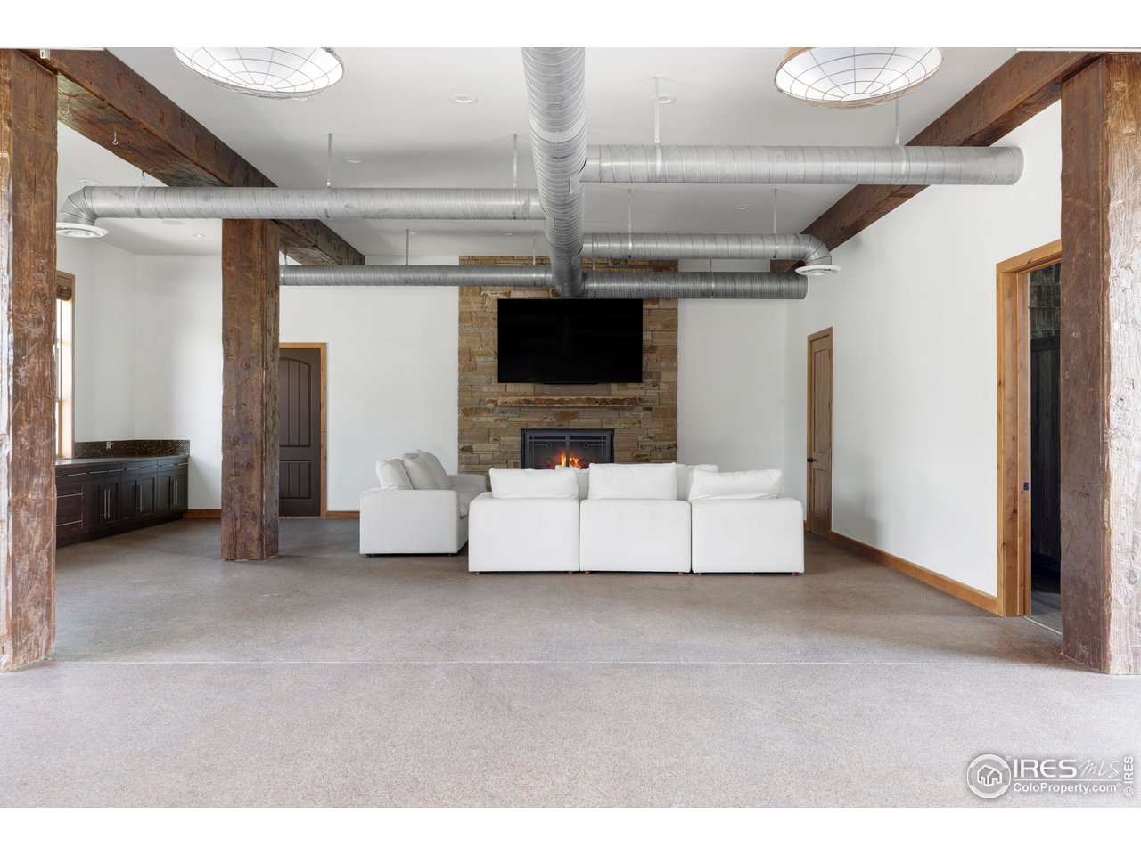 6880 St Vrain Road Longmont, CO 80503 - Photo 26 of 37 a living room with furniture and a flat screen tv