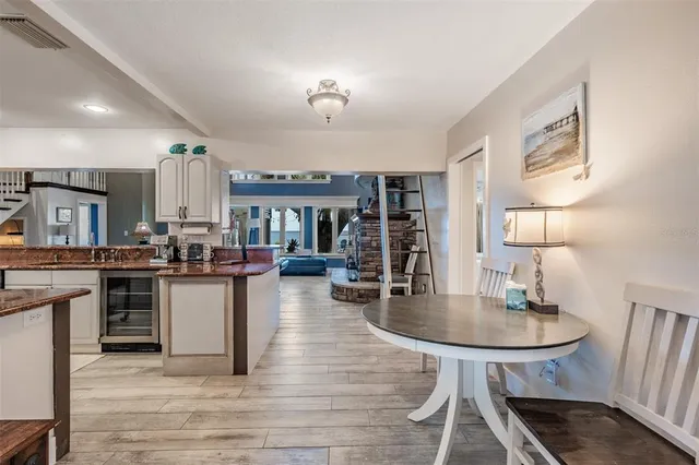 a kitchen with stainless steel appliances kitchen island granite countertop a stove top oven a sink a counter space and cabinets