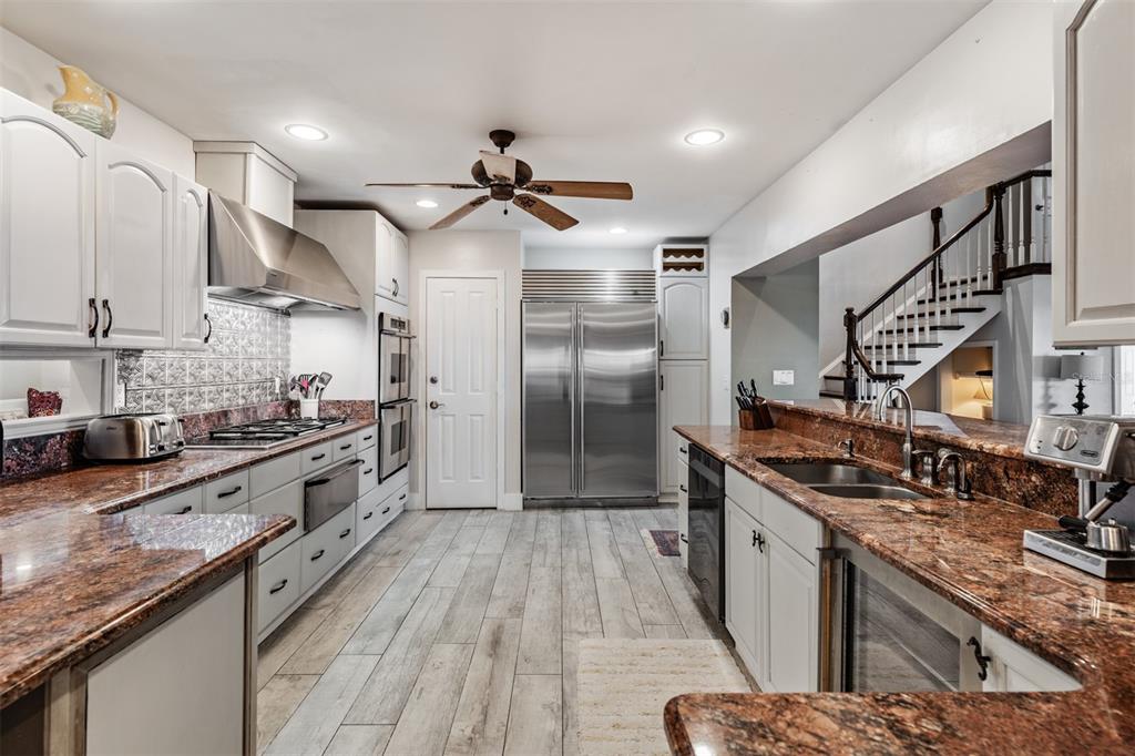 615 North Mayo Street Palm Harbor, FL 34683 - Photo 22 of 73 a large kitchen with stainless steel appliances granite countertop a stove and a sink