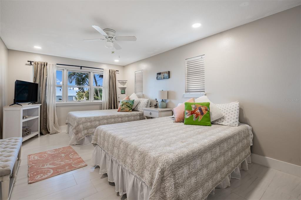 615 North Mayo Street Palm Harbor, FL 34683 - Photo 32 of 73 a bedroom with a bed and a flat screen tv