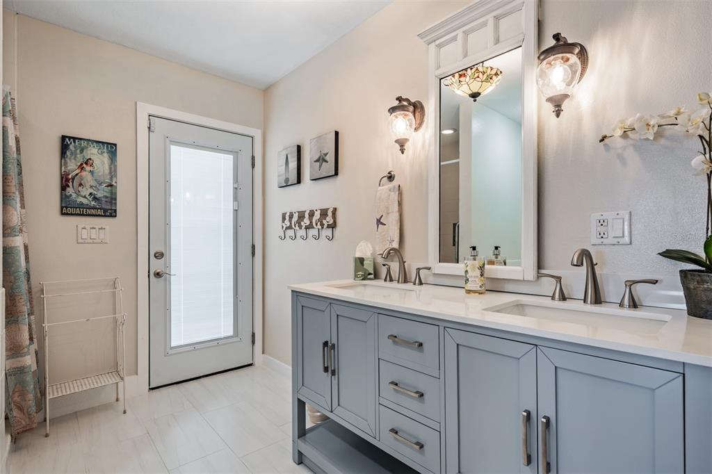 615 North Mayo Street Palm Harbor, FL 34683 - Photo 33 of 73 a bathroom with a double vanity sink and mirror