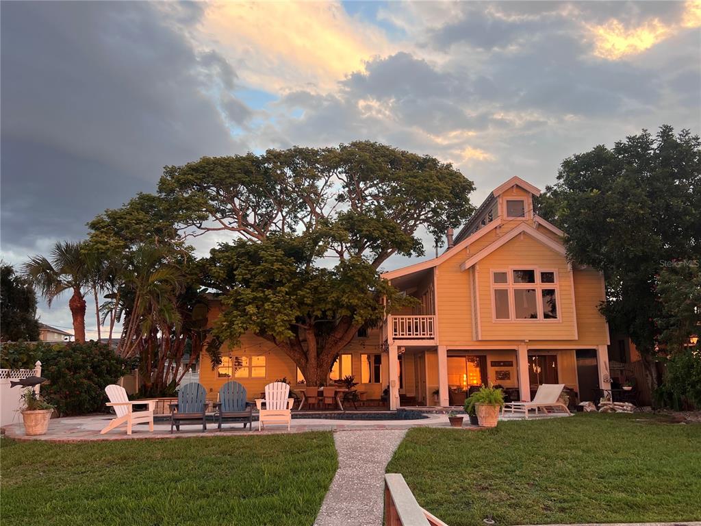 615 North Mayo Street Palm Harbor, FL 34683 - Photo 46 of 73 a front view of a building with a garden and trees
