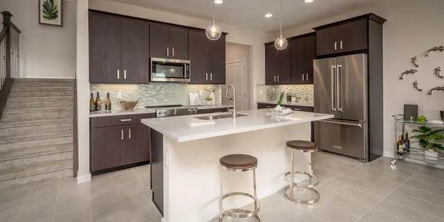 a kitchen with stainless steel appliances a refrigerator and a stove top oven