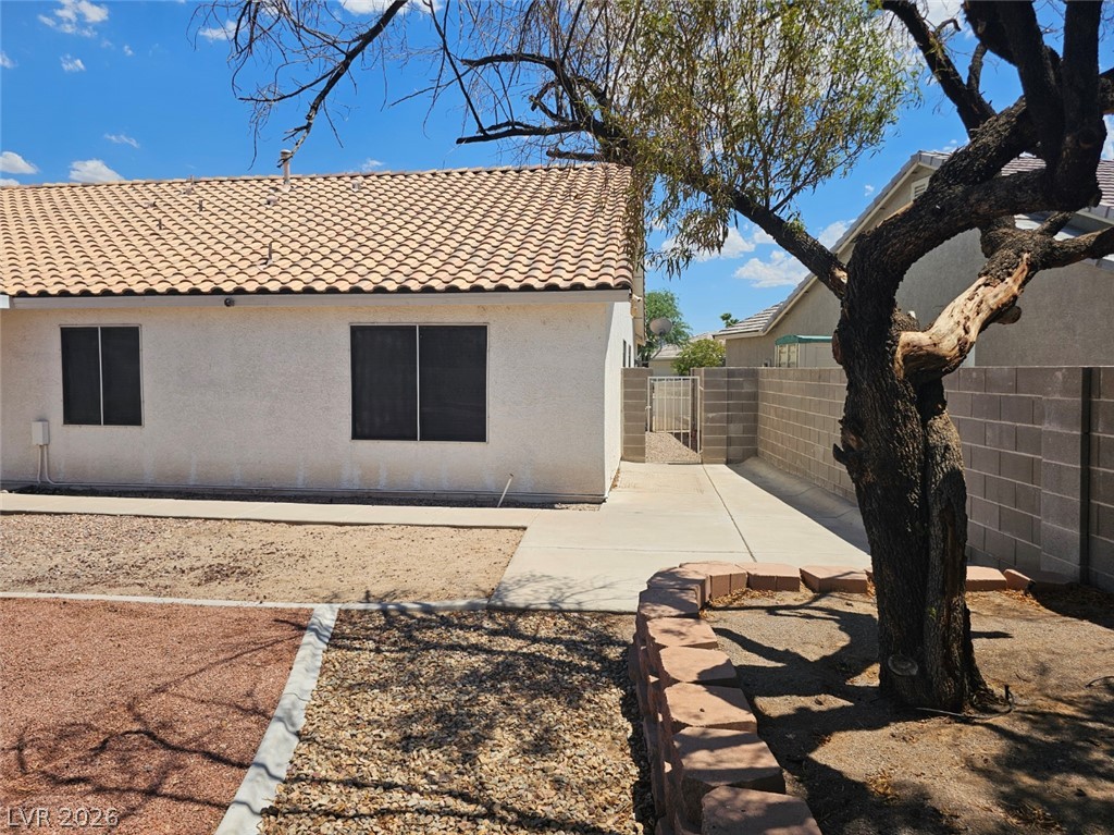 1418 Reebok Terrace Henderson, NV 89014 - Photo 35 of 38 A well-maintained side yard features a sturdy block wall, practical concrete pathways, and desert landscaping.