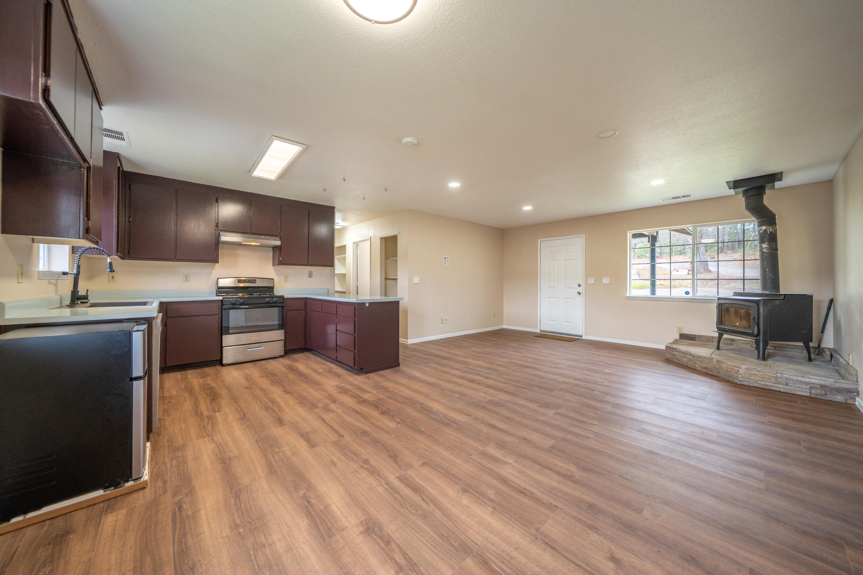 29800 Ranch Road Montgomery Creek, CA 96065 - Photo 15 of 74 a large kitchen with large windows and wooden floors